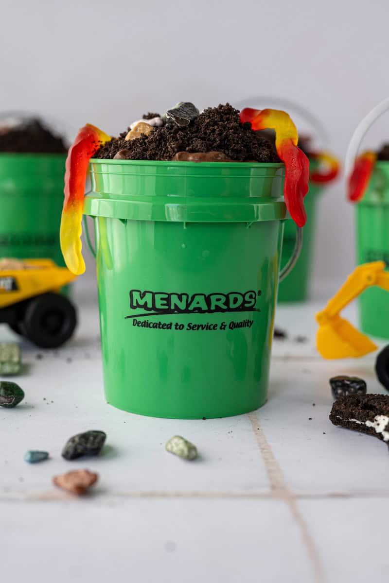 menards mini pail filled with dirt cake topped with oreos and gummy worm spilling out the side.
