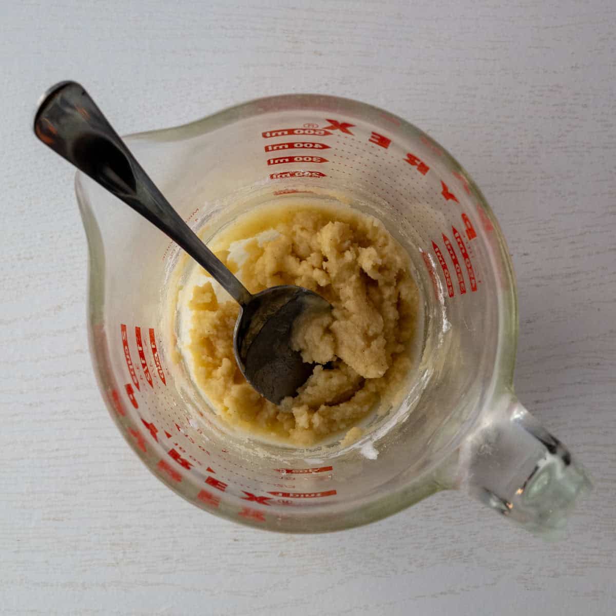 melted butter mixed with gluten free flour to create a roux in a glass measuring cup.