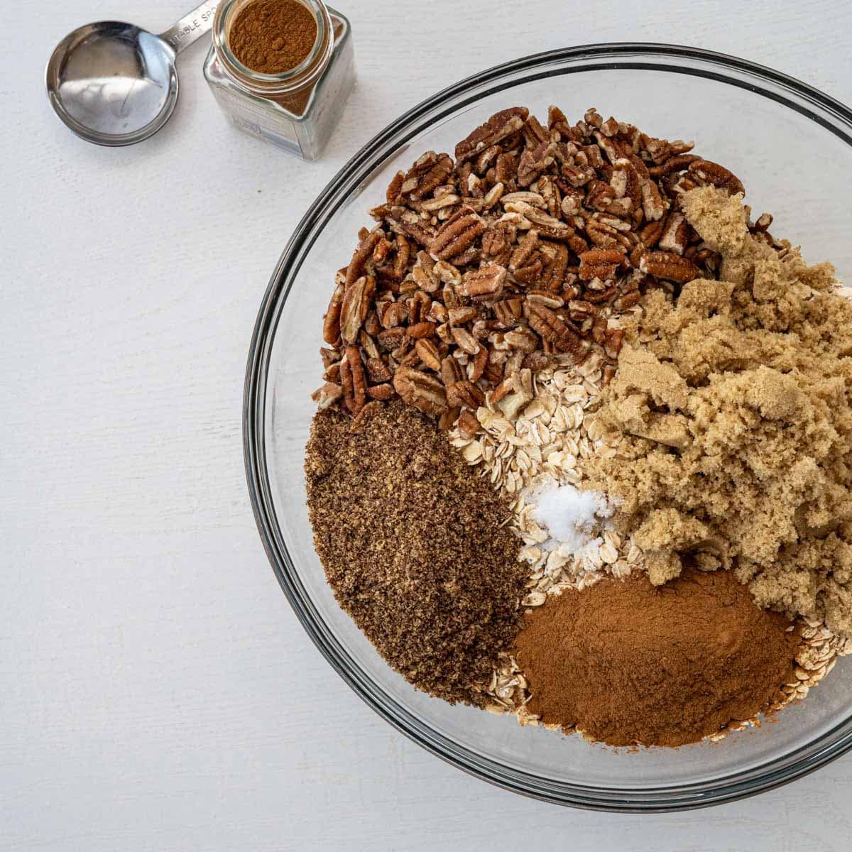 dry granola ingredients in a large glass bowl.
