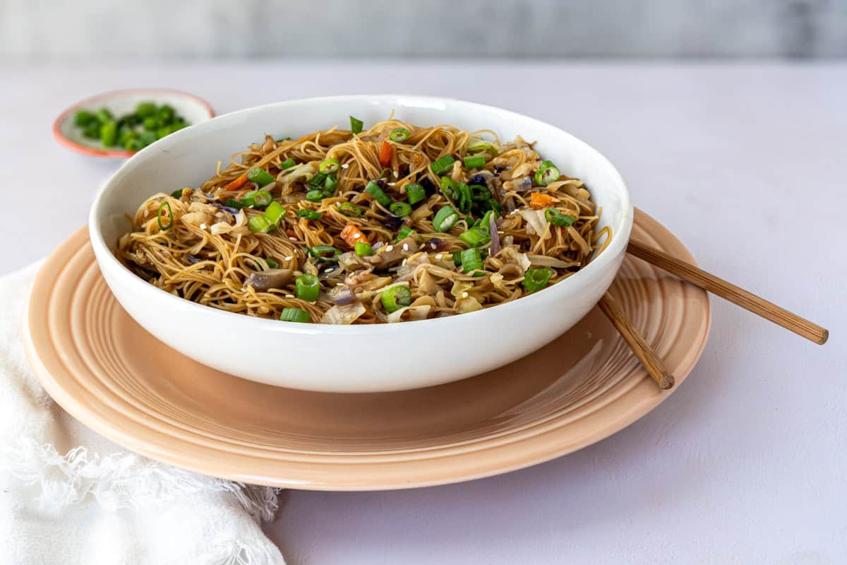 bowl of chow mein noodles with chop sticks.