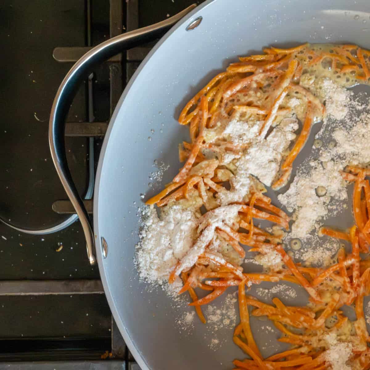 melted butter, shredded carrots and gluten free flour in a skillet.