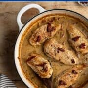 large white pan with baked marry me chicken with a wooden spoon.