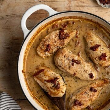 large pan with finished marry me chicken on a wooden table.