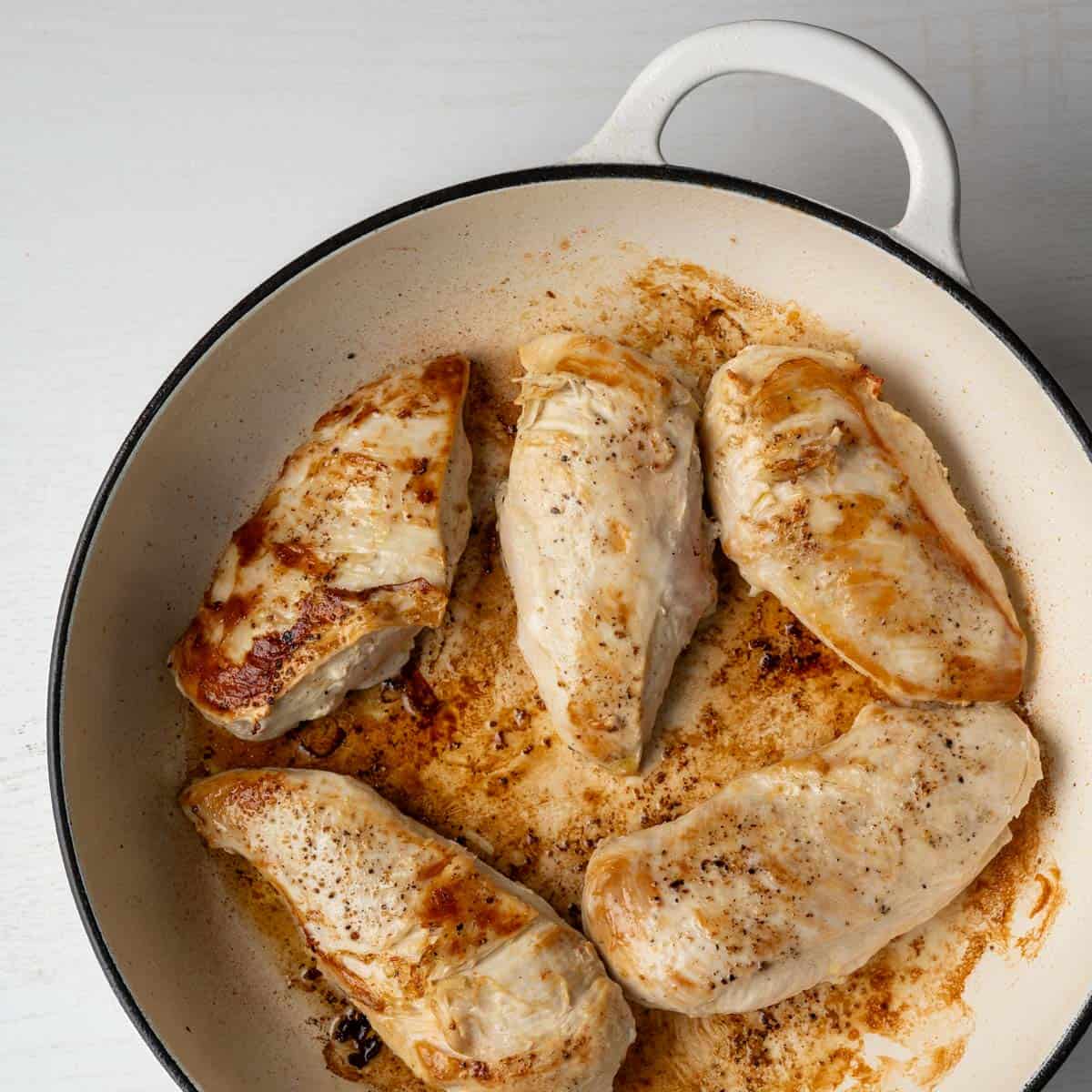 seared chicken breasts in a pan.