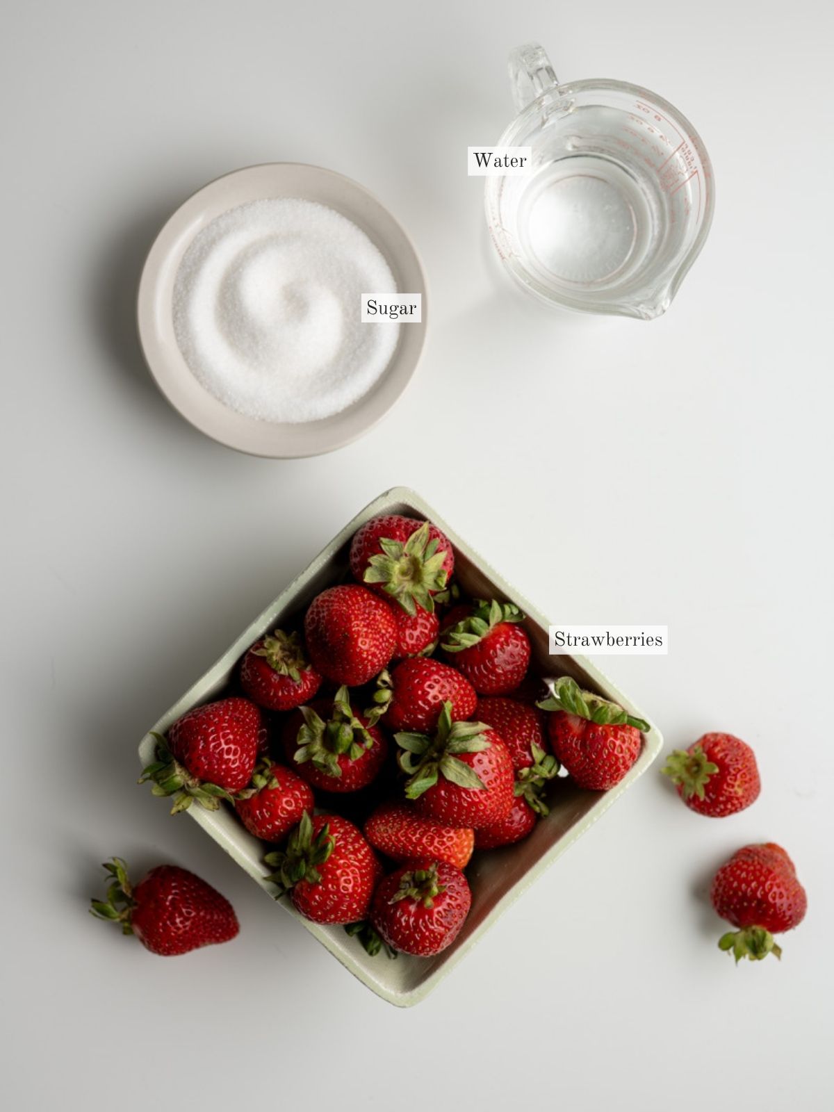 ingredients to make homemade strawberry simple syrup.