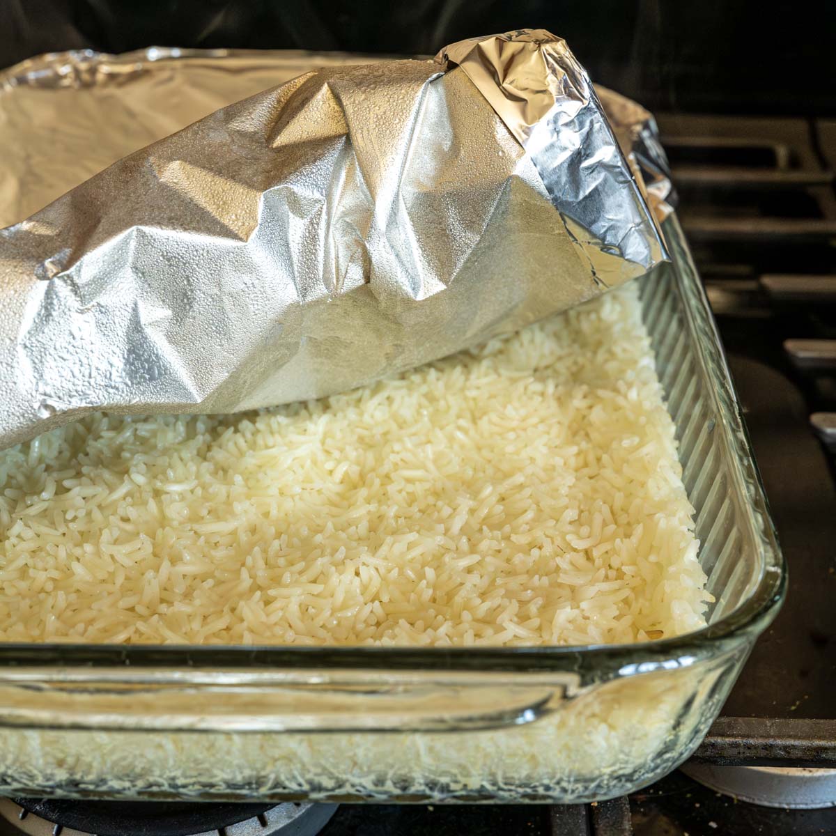 baked cilatnro lime rice with the alumiun foil peeled back.