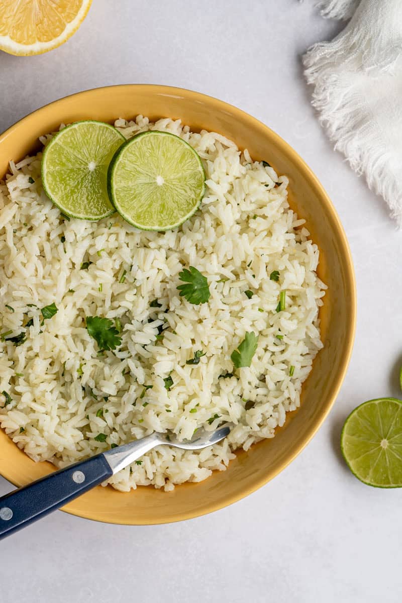 close up of baked cilantro lime rice topped with lime slices. 