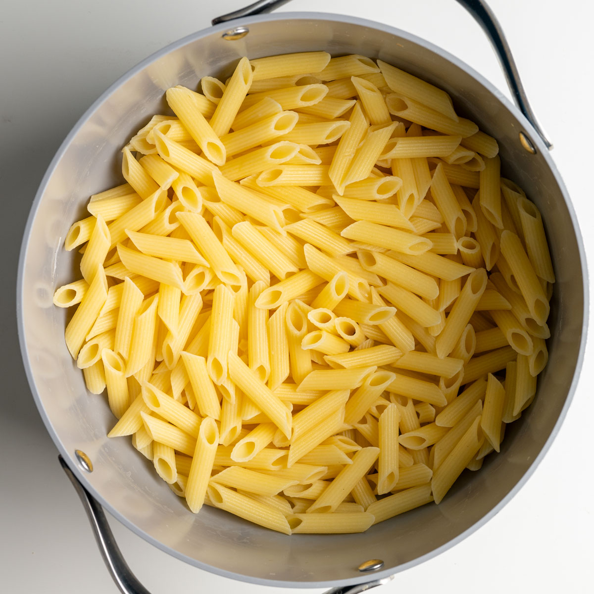 cooked penne pasta in a stock pot.