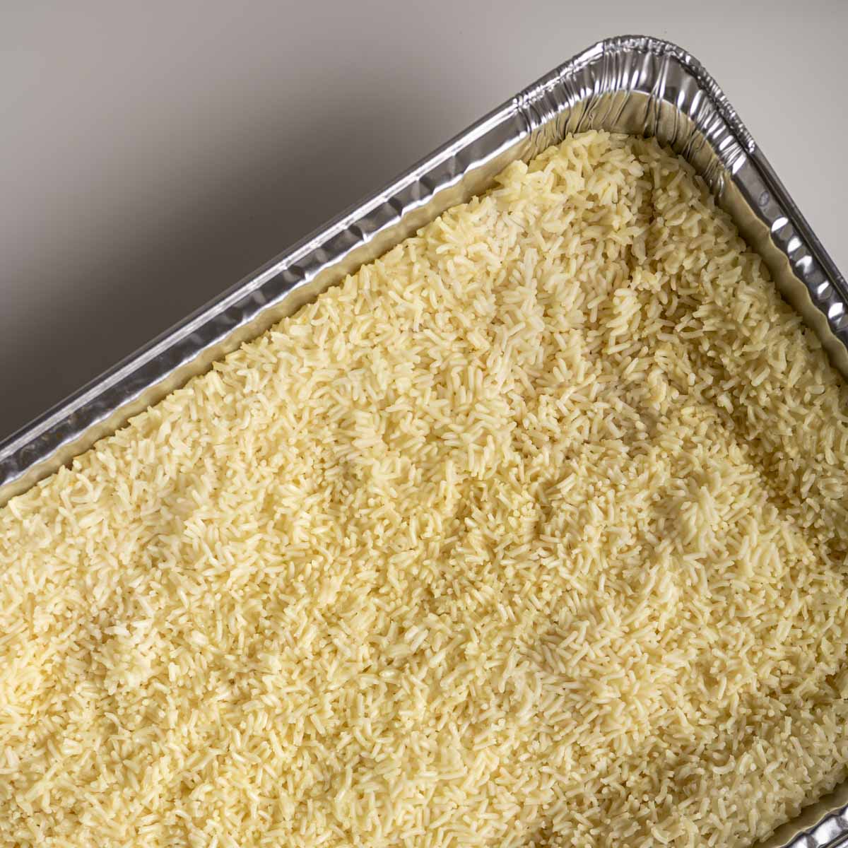 cooked white rice in a steam table pan.