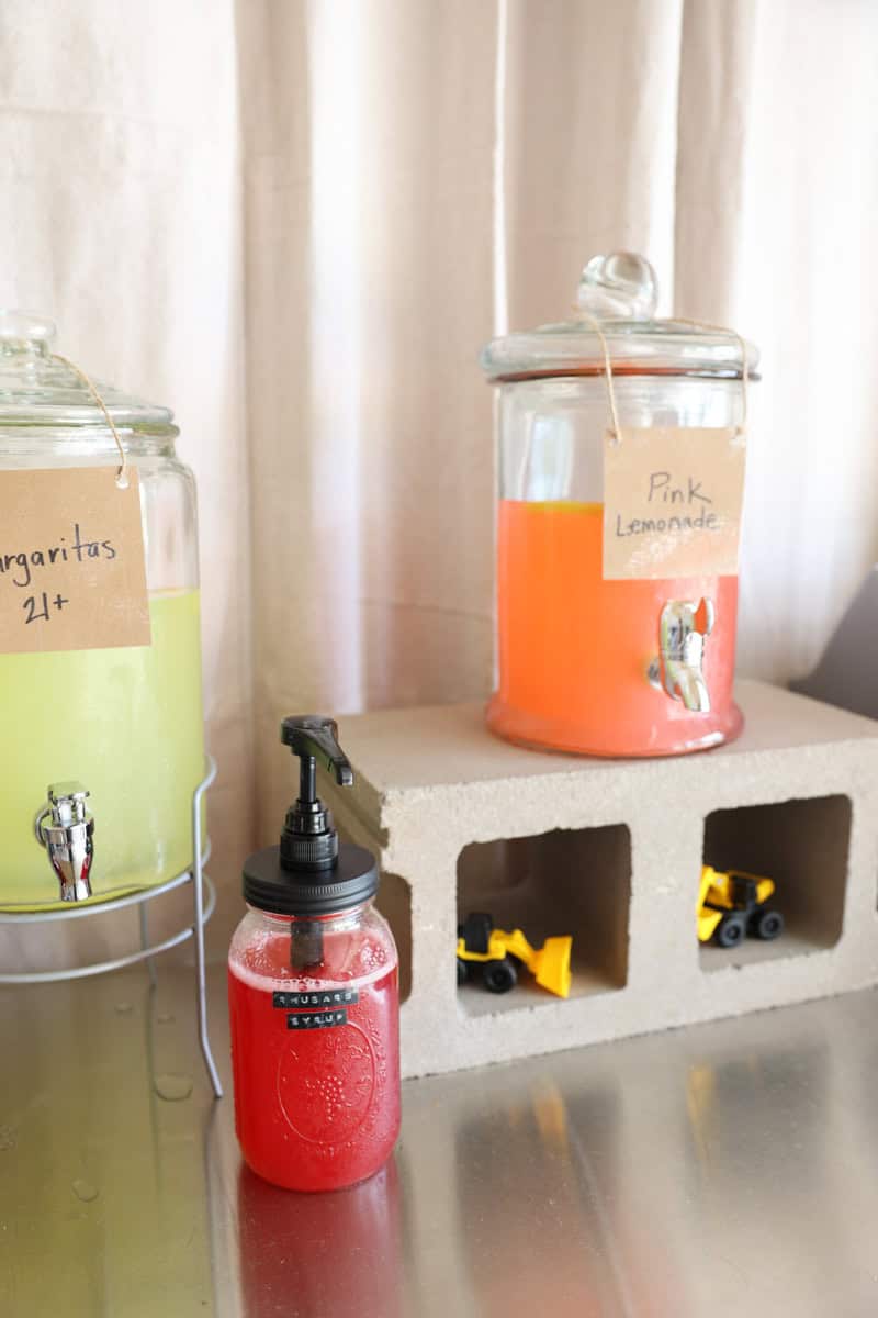 homemade rhubarb syrup on a lemonade bar at a graduation party.