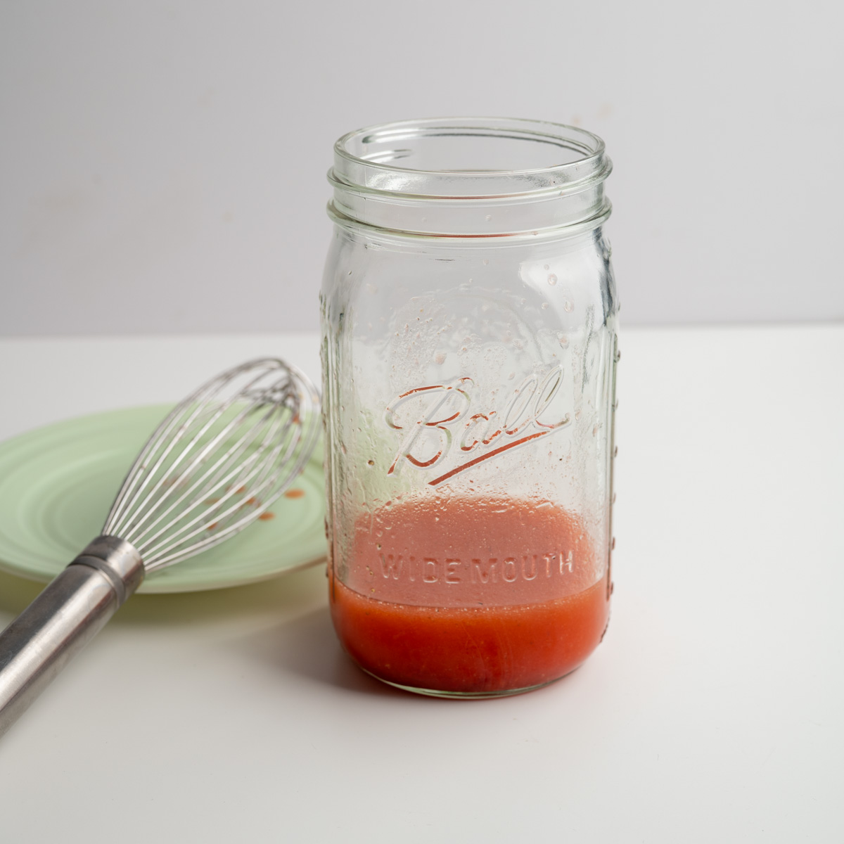 mixed strawberry vinaigrette in a mason jar.