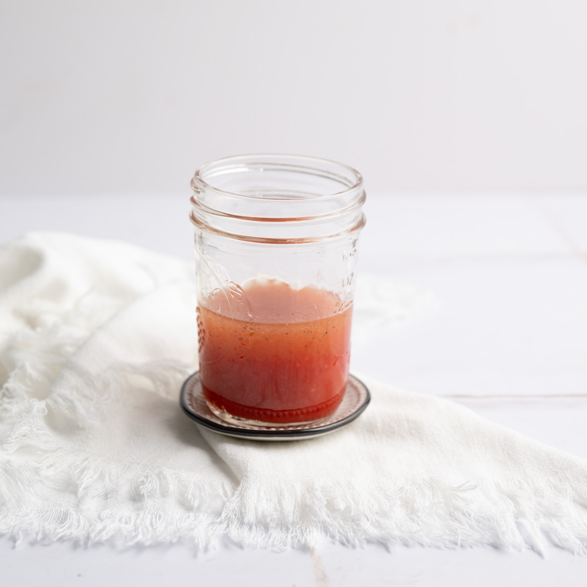 mason jar holding strawberry vinaigrette. 
