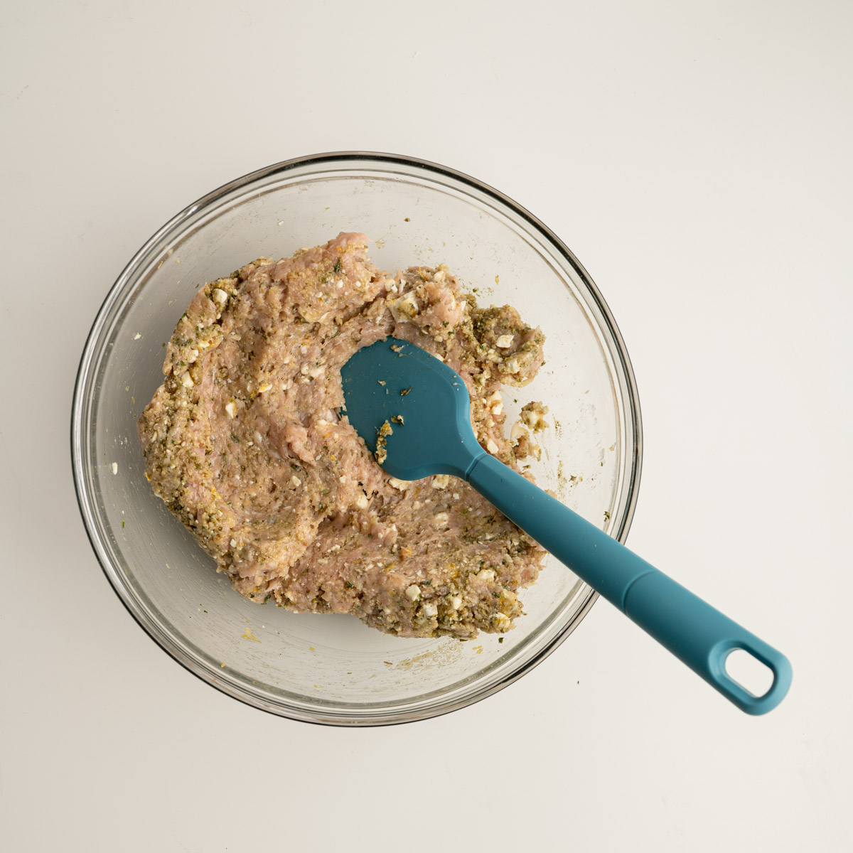 chicken meatball ingredients in a glass bowl.