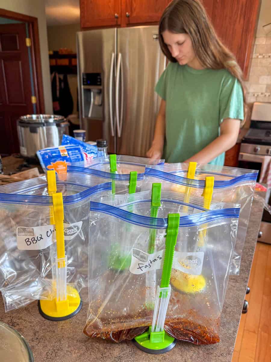 countertop filled with zip top bag holders while prepping food.