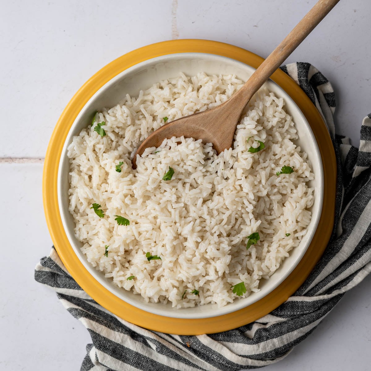 big bowl of coconut rice with a wooden spoon. 