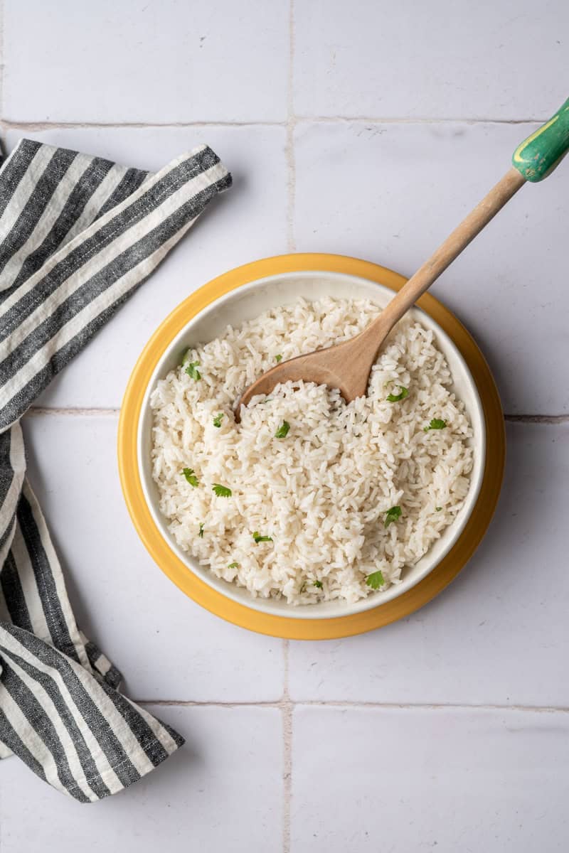 big bowl of baked coconut rice topped with chopped cilantro.