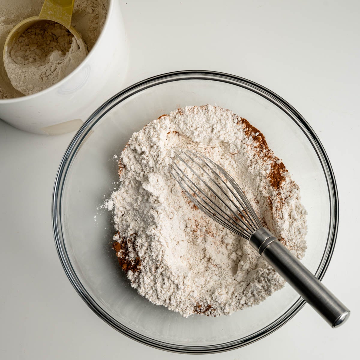 dry ingredients in a glass bowl with a whisk.