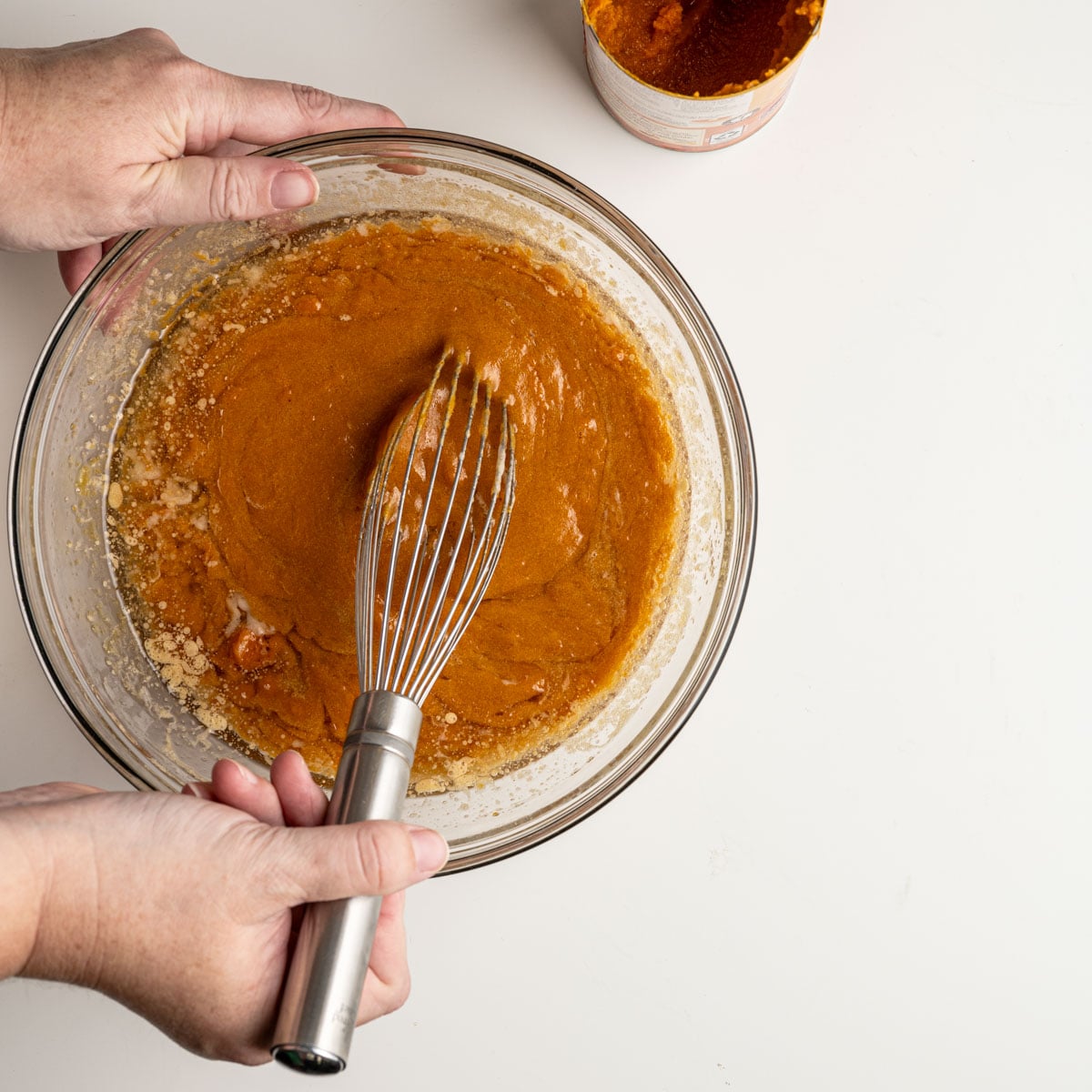 all wet ingredients in a glass bowl whisking.