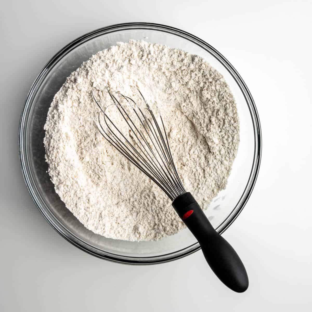 dry ingredients in a glass bowl with a whisk.