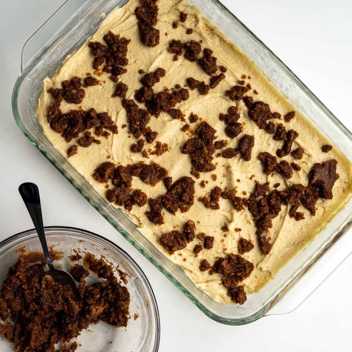 half of the sturesel sprinkled over the cake batter.