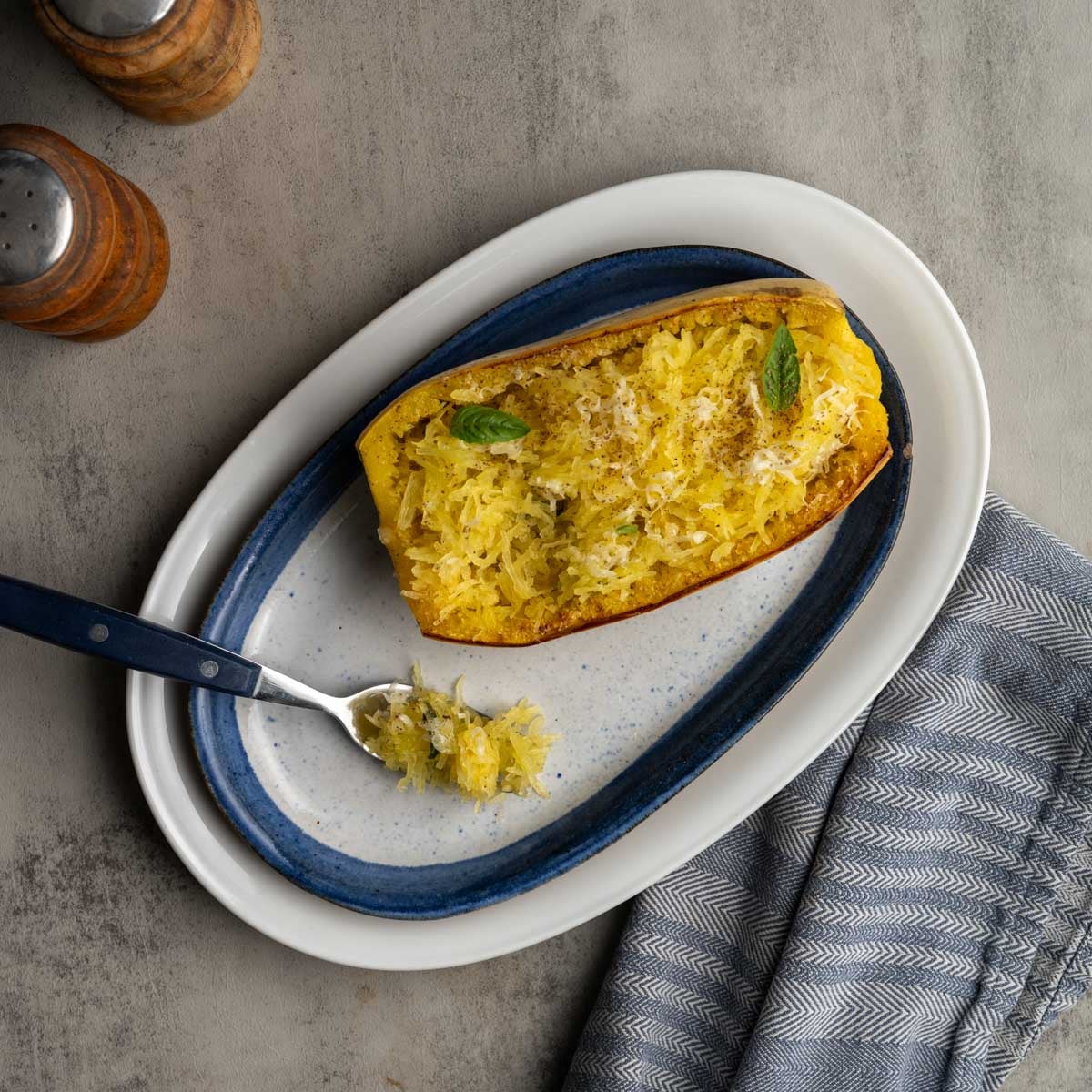 spaghetti squash topped with parmesan cheese and fresh basil.