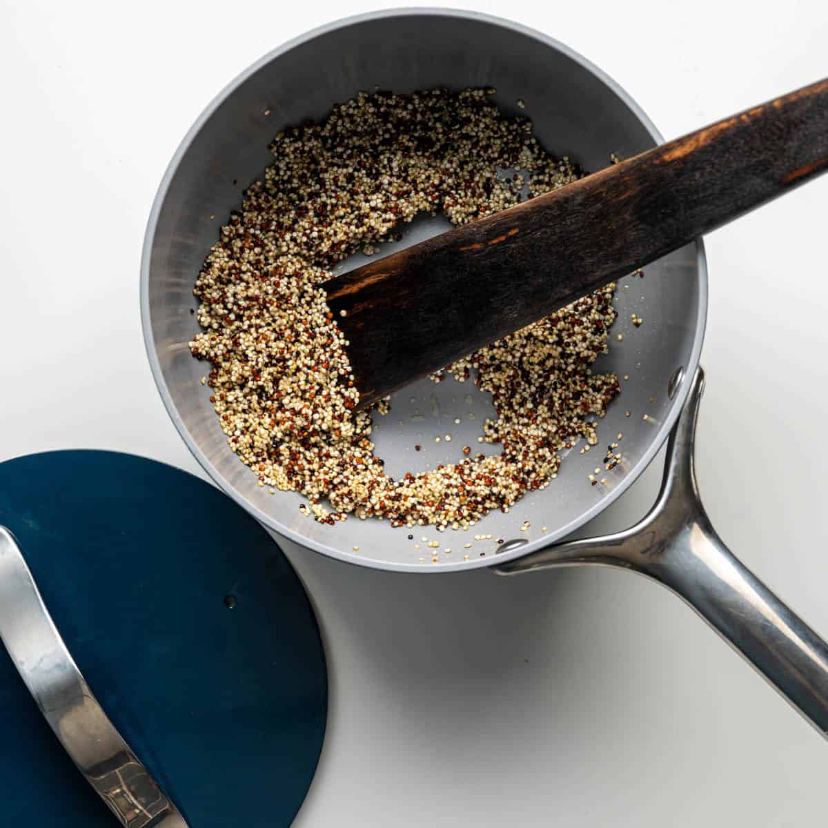 saucepan with roasted quinoa with garlic olive oil.