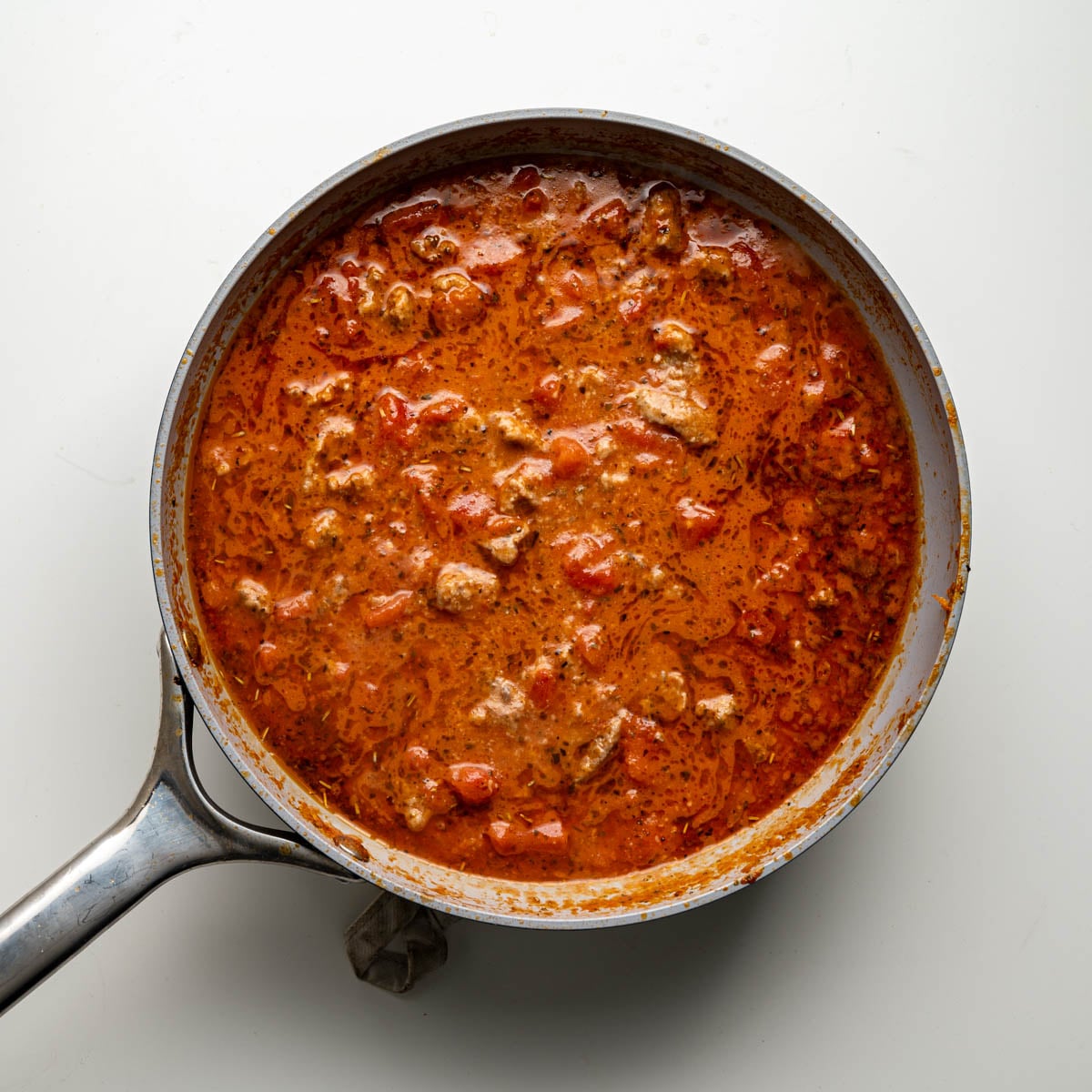 skillet with canned tomatoes, cooked Italian turkey sausage and cottage cheese.
