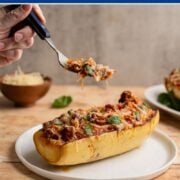 forkfull of spaghetti squash above a stuffed spaghetti boat.